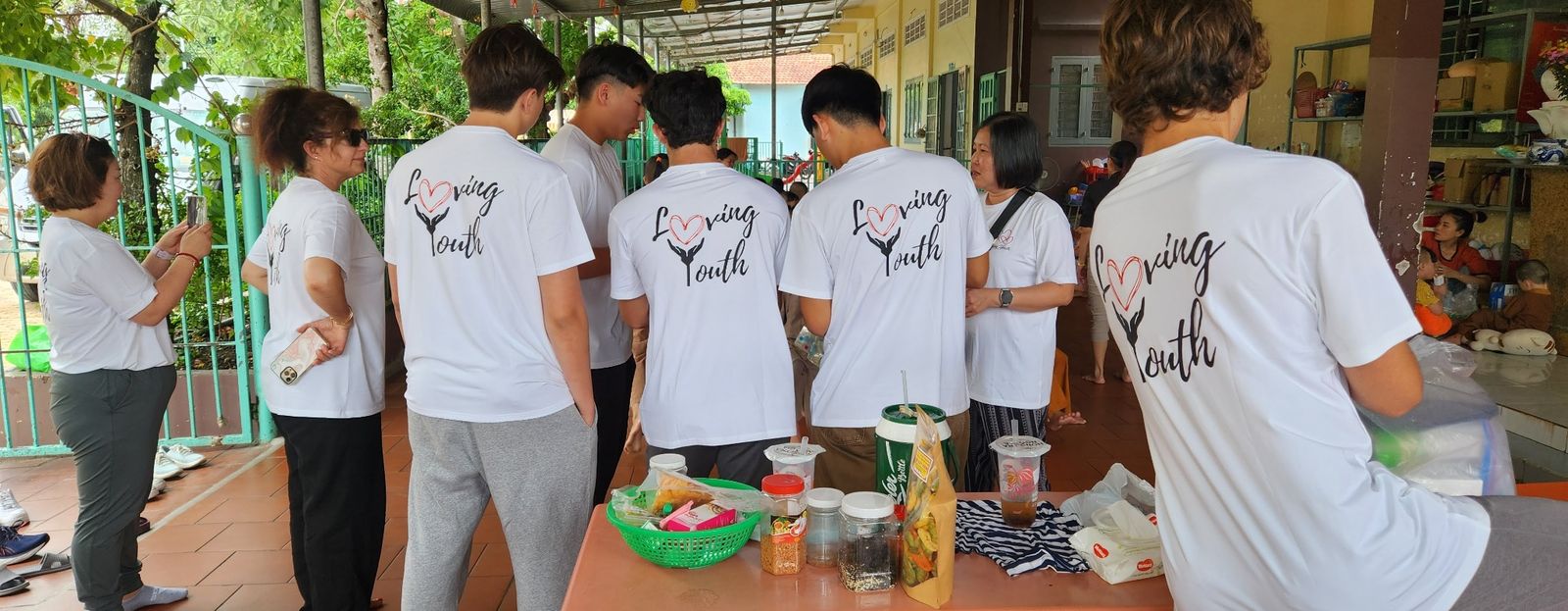 Backs of Loving Youth shirts at the orphanage